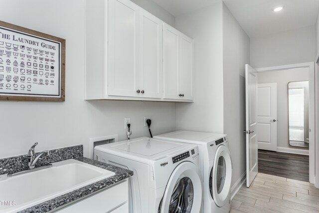 2516 Del Webb Gardens Dr, Fuquay Varina, NC 27526 - laundry room featuring washer and clothes dryer, cabinet space, light wood-style flooring, recessed lighting, and baseboards