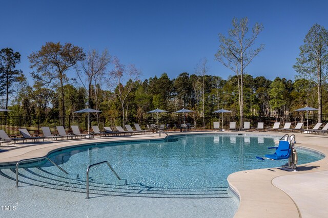 2516 Del Webb Gardens Dr, Fuquay Varina, NC 27526 - community pool featuring a patio and view of scattered trees