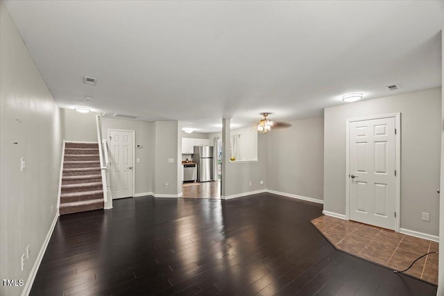 2920 Barrymore St Unit 106, Raleigh, NC 27603 - unfurnished living room featuring wood-type flooring and stairway