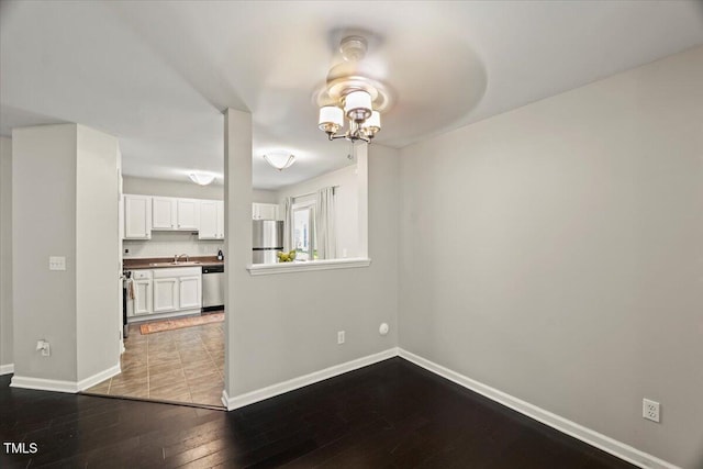 2920 Barrymore St Unit 106, Raleigh, NC 27603 - unfurnished dining area featuring hardwood / wood-style flooring and a chandelier