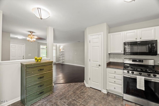 2920 Barrymore St Unit 106, Raleigh, NC 27603 - kitchen with black microwave, stainless steel gas range oven, white cabinets, tasteful backsplash, and dark countertops
