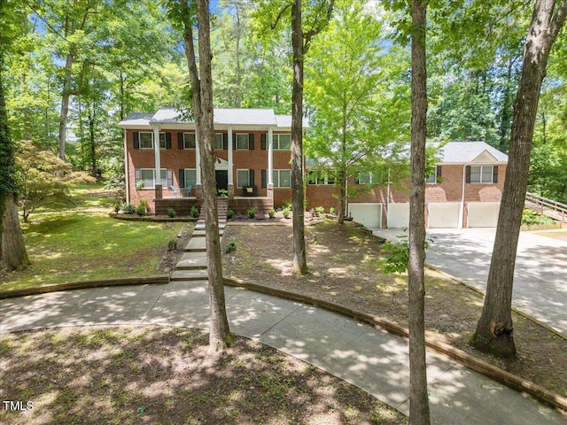9801 Honeycutt Rd, Raleigh, NC 27614 - view of front facade with brick siding, covered porch, and view of scattered trees