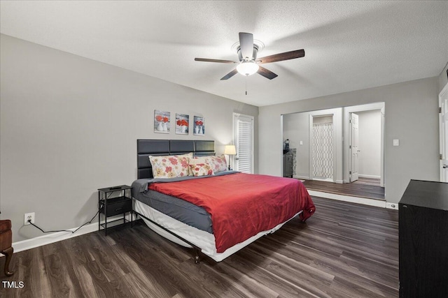 9801 Honeycutt Rd, Raleigh, NC 27614 - bedroom with wood finished floors, baseboards, ceiling fan, and a textured ceiling