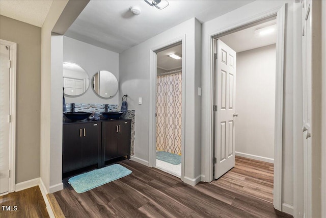9801 Honeycutt Rd, Raleigh, NC 27614 - full bathroom featuring wood finished floors, double vanity, baseboards, and a shower with curtain