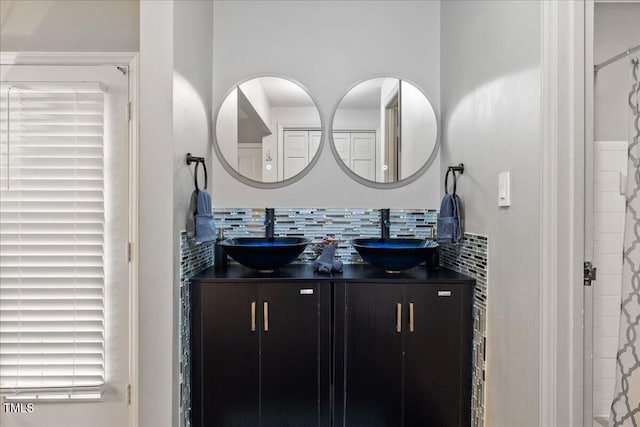 9801 Honeycutt Rd, Raleigh, NC 27614 - bathroom featuring double vanity and tasteful backsplash