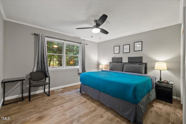 9801 Honeycutt Rd, Raleigh, NC 27614 - bedroom featuring a textured ceiling, wood finished floors, baseboards, crown molding, and a ceiling fan