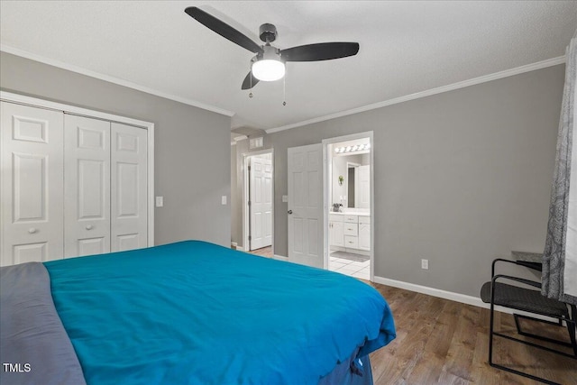 9801 Honeycutt Rd, Raleigh, NC 27614 - bedroom featuring a closet, wood finished floors, crown molding, baseboards, and ceiling fan