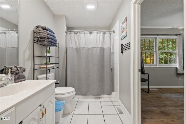 9801 Honeycutt Rd, Raleigh, NC 27614 - full bath featuring vanity, toilet, a textured ceiling, a shower with shower curtain, and baseboards