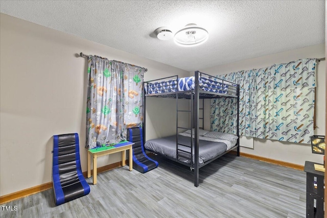 9801 Honeycutt Rd, Raleigh, NC 27614 - bedroom featuring baseboards, wood finished floors, and a textured ceiling