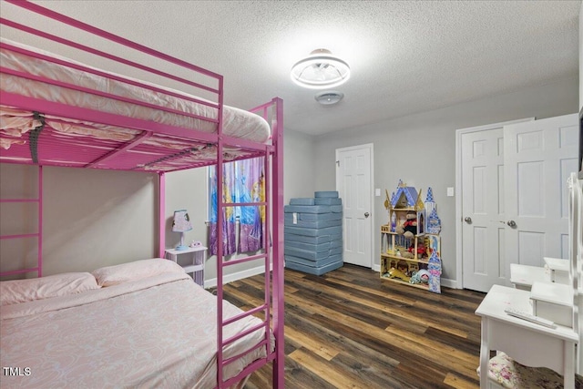 9801 Honeycutt Rd, Raleigh, NC 27614 - bedroom featuring dark wood-style flooring, a textured ceiling, and baseboards