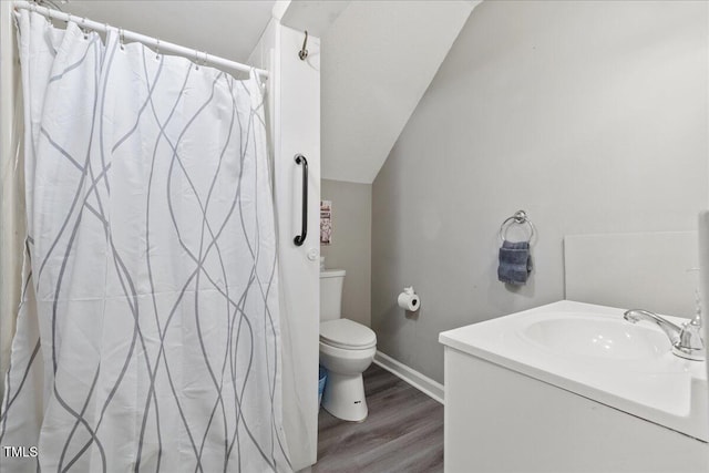 9801 Honeycutt Rd, Raleigh, NC 27614 - full bath featuring toilet, wood finished floors, baseboards, vanity, and a shower with shower curtain