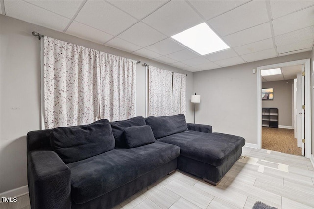 9801 Honeycutt Rd, Raleigh, NC 27614 - living room featuring a drop ceiling and baseboards