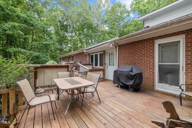 9801 Honeycutt Rd, Raleigh, NC 27614 - wooden deck with a grill, outdoor dining space, and view of scattered trees