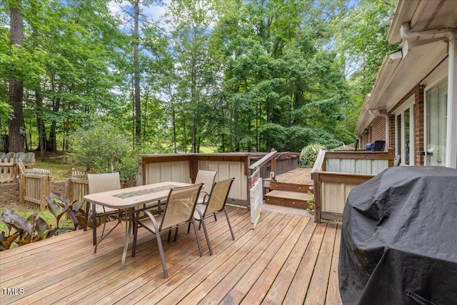 9801 Honeycutt Rd, Raleigh, NC 27614 - wooden deck featuring outdoor dining area, view of scattered trees, and a grill