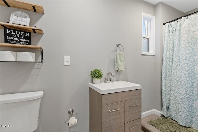9801 Honeycutt Rd, Raleigh, NC 27614 - full bath featuring vanity, toilet, baseboards, and a shower with shower curtain