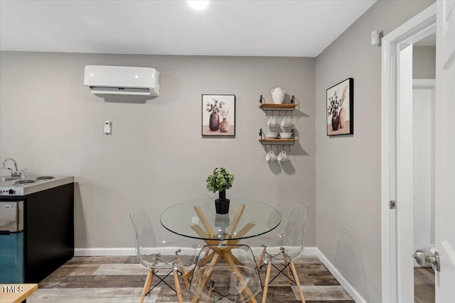 9801 Honeycutt Rd, Raleigh, NC 27614 - dining area featuring a wall mounted air conditioner, wood finished floors, and baseboards