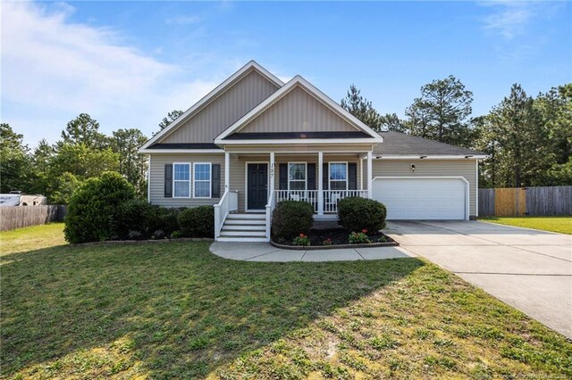 187 Gunner Ct, Broadway, NC 27505 - view of front facade with a garage, a porch, and concrete driveway