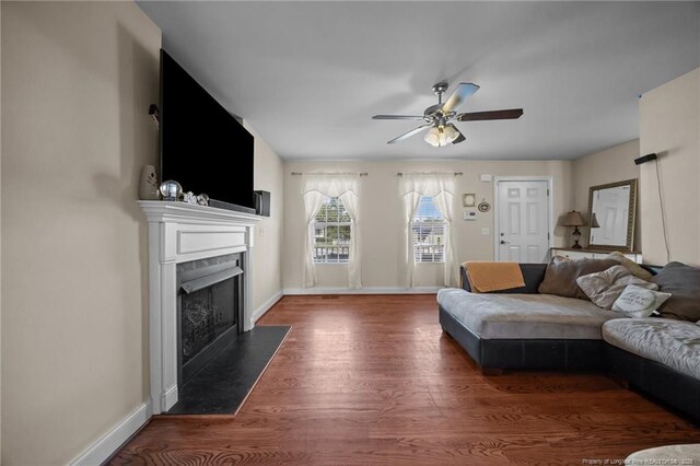 187 Gunner Ct, Broadway, NC 27505 - living area with wood finished floors, a fireplace with flush hearth, a ceiling fan, and baseboards