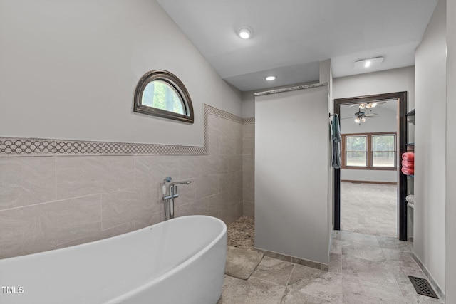 502 Hillcrest Rd, Apex, NC 27502 - full bathroom with a freestanding tub, a walk in shower, a ceiling fan, tile walls, and recessed lighting