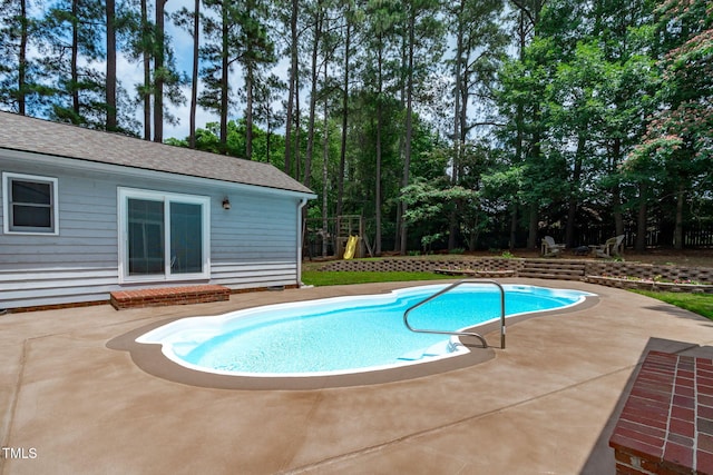 502 Hillcrest Rd, Apex, NC 27502 - outdoor pool featuring a patio area and view of wooded area