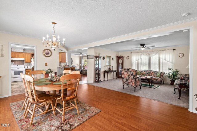 4403 Jeffries Rd, Durham, NC 27704 - dining room with a ceiling fan, ornamental molding, a chandelier, light wood-type flooring, and a textured ceiling