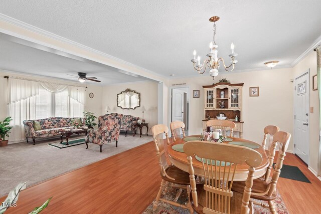 4403 Jeffries Rd, Durham, NC 27704 - dining room featuring crown molding, light wood-type flooring, a chandelier, and a ceiling fan