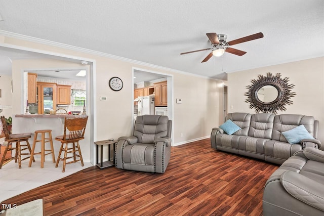4403 Jeffries Rd, Durham, NC 27704 - living area with a ceiling fan, wood finished floors, crown molding, a textured ceiling, and baseboards
