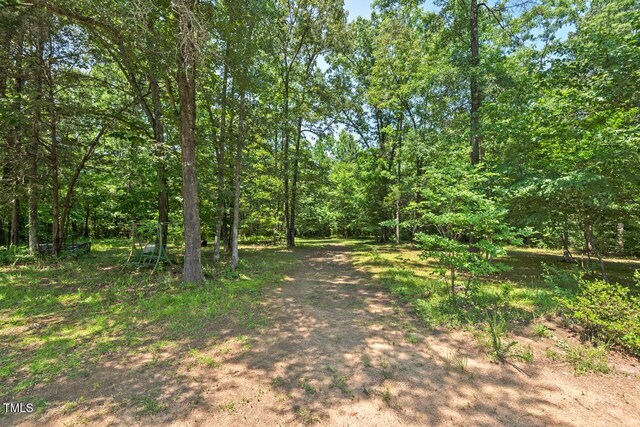 4403 Jeffries Rd, Durham, NC 27704 - view of dirt / gravel road featuring a wooded view
