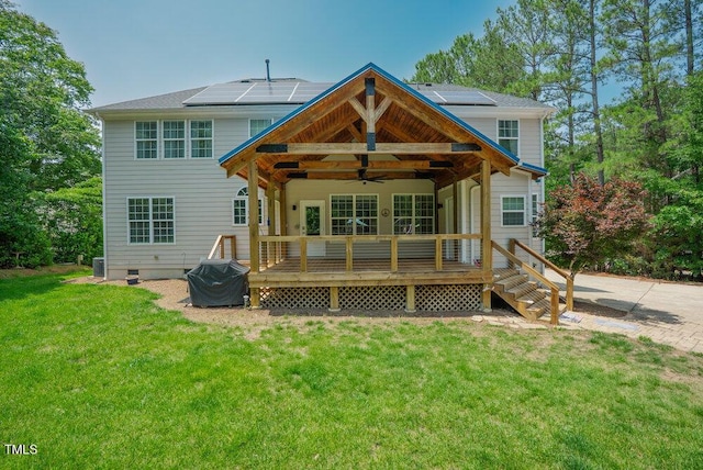 1005 Hidden River Ct, Raleigh, NC 27614 - back of house featuring ceiling fan, a lawn, roof mounted solar panels, and a deck