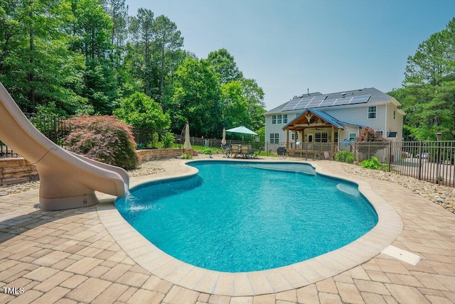 1005 Hidden River Ct, Raleigh, NC 27614 - view of swimming pool with a water slide, a patio area, and outdoor dining area