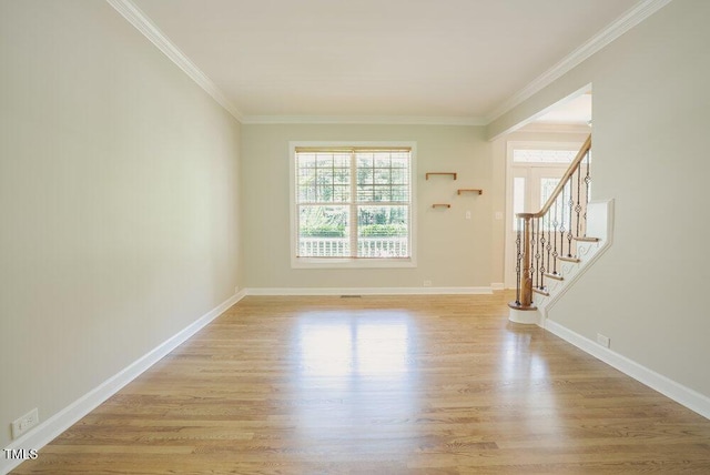1005 Hidden River Ct, Raleigh, NC 27614 - unfurnished room featuring plenty of natural light, light wood-style floors, ornamental molding, stairs, and baseboards