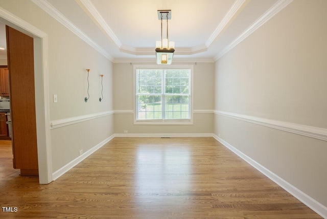 1005 Hidden River Ct, Raleigh, NC 27614 - spare room with a tray ceiling, light wood-style floors, crown molding, and baseboards