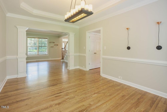 1005 Hidden River Ct, Raleigh, NC 27614 - unfurnished room featuring decorative columns, light wood finished floors, a chandelier, stairway, and crown molding