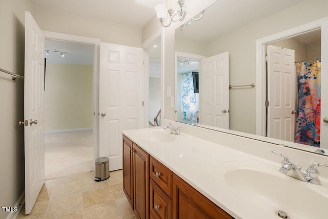 1005 Hidden River Ct, Raleigh, NC 27614 - full bathroom with double vanity and a chandelier
