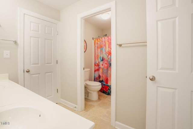 1005 Hidden River Ct, Raleigh, NC 27614 - bathroom featuring toilet, double vanity, baseboards, and curtained shower