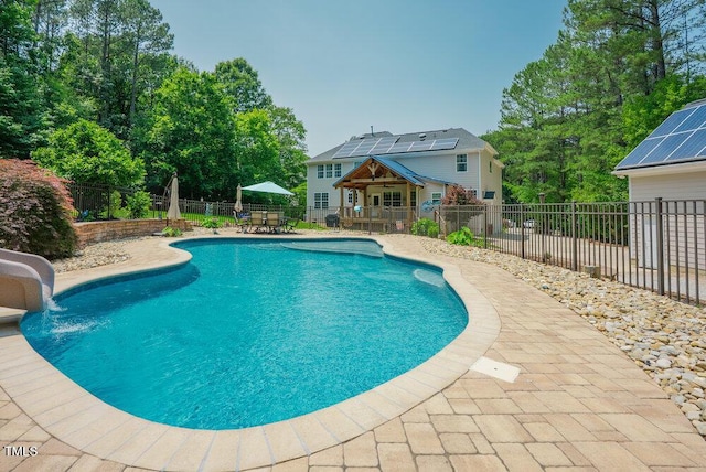 1005 Hidden River Ct, Raleigh, NC 27614 - view of pool with a water slide, a patio, a fenced backyard, and outdoor dining space