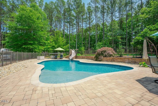 1005 Hidden River Ct, Raleigh, NC 27614 - view of swimming pool with a water slide, a patio area, and a fenced backyard