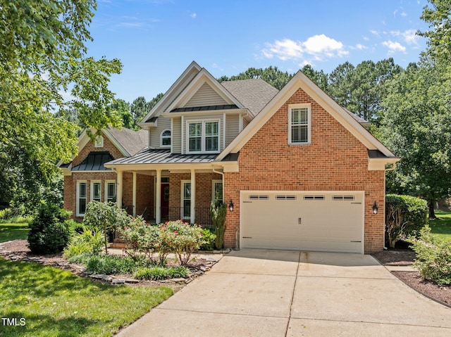 5108 Briton Pl, Fuquay Varina, NC 27526 - view of front facade featuring a standing seam roof, concrete driveway, covered porch, metal roof, and brick siding