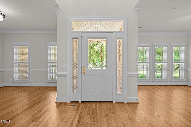 5108 Briton Pl, Fuquay Varina, NC 27526 - foyer entrance with wood finished floors, crown molding, healthy amount of natural light, and baseboards