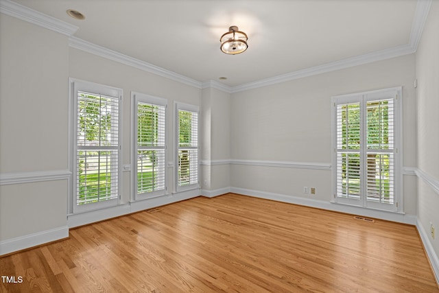 5108 Briton Pl, Fuquay Varina, NC 27526 - empty room featuring light wood-style flooring, healthy amount of natural light, crown molding, and baseboards
