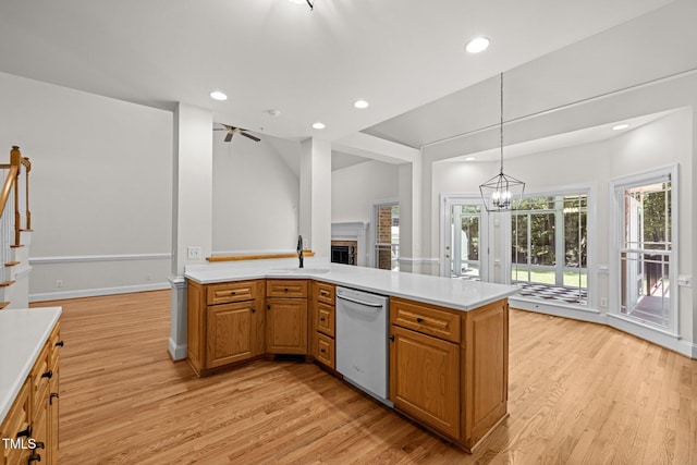5108 Briton Pl, Fuquay Varina, NC 27526 - kitchen with dishwasher, light wood-type flooring, light countertops, a fireplace, and recessed lighting