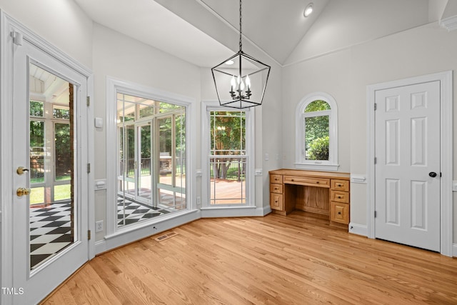 5108 Briton Pl, Fuquay Varina, NC 27526 - unfurnished dining area featuring vaulted ceiling, light wood finished floors, and a chandelier