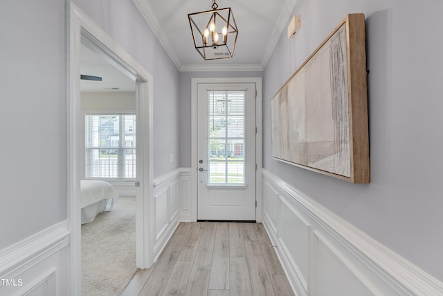 3020 High Plains Dr, Fuquay Varina, NC 27526 - doorway to outside featuring a decorative wall, plenty of natural light, a chandelier, ornamental molding, and light wood-style floors