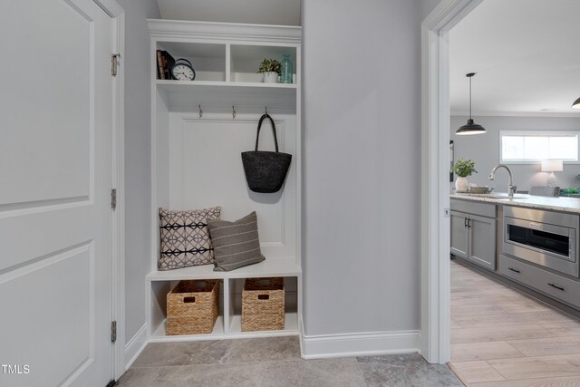 3020 High Plains Dr, Fuquay Varina, NC 27526 - mudroom featuring a sink, baseboards, and crown molding
