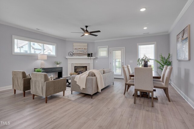 3020 High Plains Dr, Fuquay Varina, NC 27526 - living area featuring light wood-style floors, ceiling fan, a tile fireplace, ornamental molding, and plenty of natural light