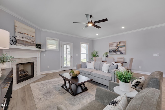 3020 High Plains Dr, Fuquay Varina, NC 27526 - living area featuring light wood finished floors, crown molding, ceiling fan, baseboards, and a fireplace
