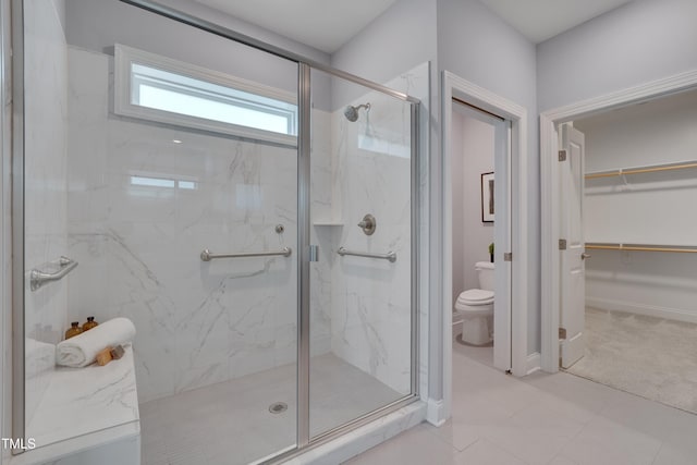 3020 High Plains Dr, Fuquay Varina, NC 27526 - bathroom with toilet, a marble finish shower, a spacious closet, and baseboards