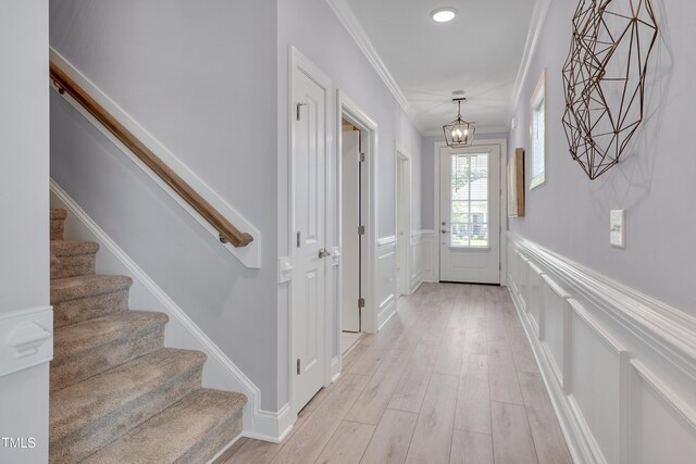 3020 High Plains Dr, Fuquay Varina, NC 27526 - foyer entrance featuring stairs, a chandelier, wainscoting, ornamental molding, and light wood-style flooring