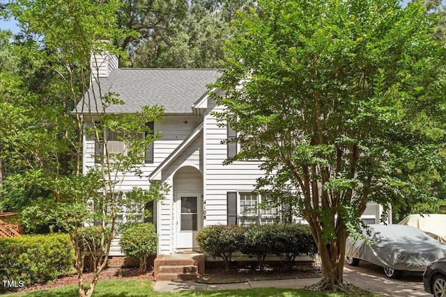 4108 Lazyriver Ln, Durham, NC 27712 - view of front of home with a shingled roof and a chimney