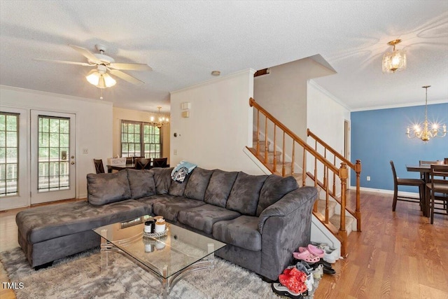 4108 Lazyriver Ln, Durham, NC 27712 - living room featuring a chandelier, wood finished floors, stairs, crown molding, and a textured ceiling